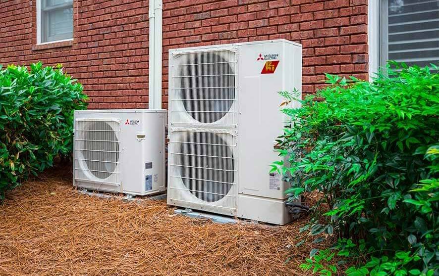 homeowner enjoying zoned comfort of ductless cooling and heating