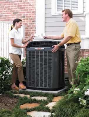Woman and HVAC dealer outside by A/C unit. 10 best air conditioning brands. Air Plus Heating & Air Conditioning.